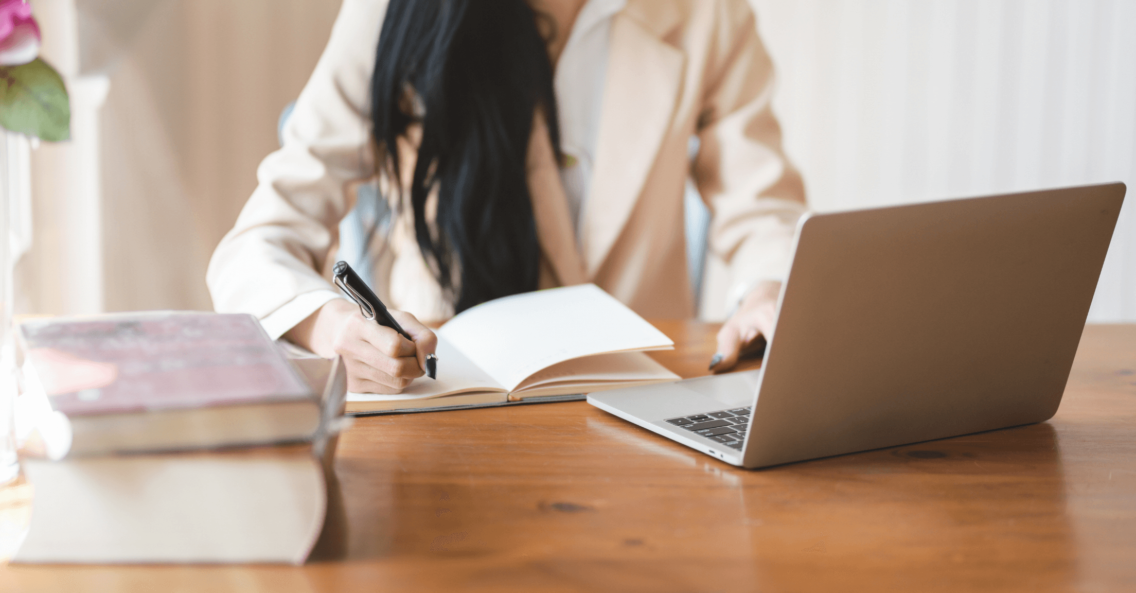 Woman taking notes while watching a RightCapital webinar on her laptop