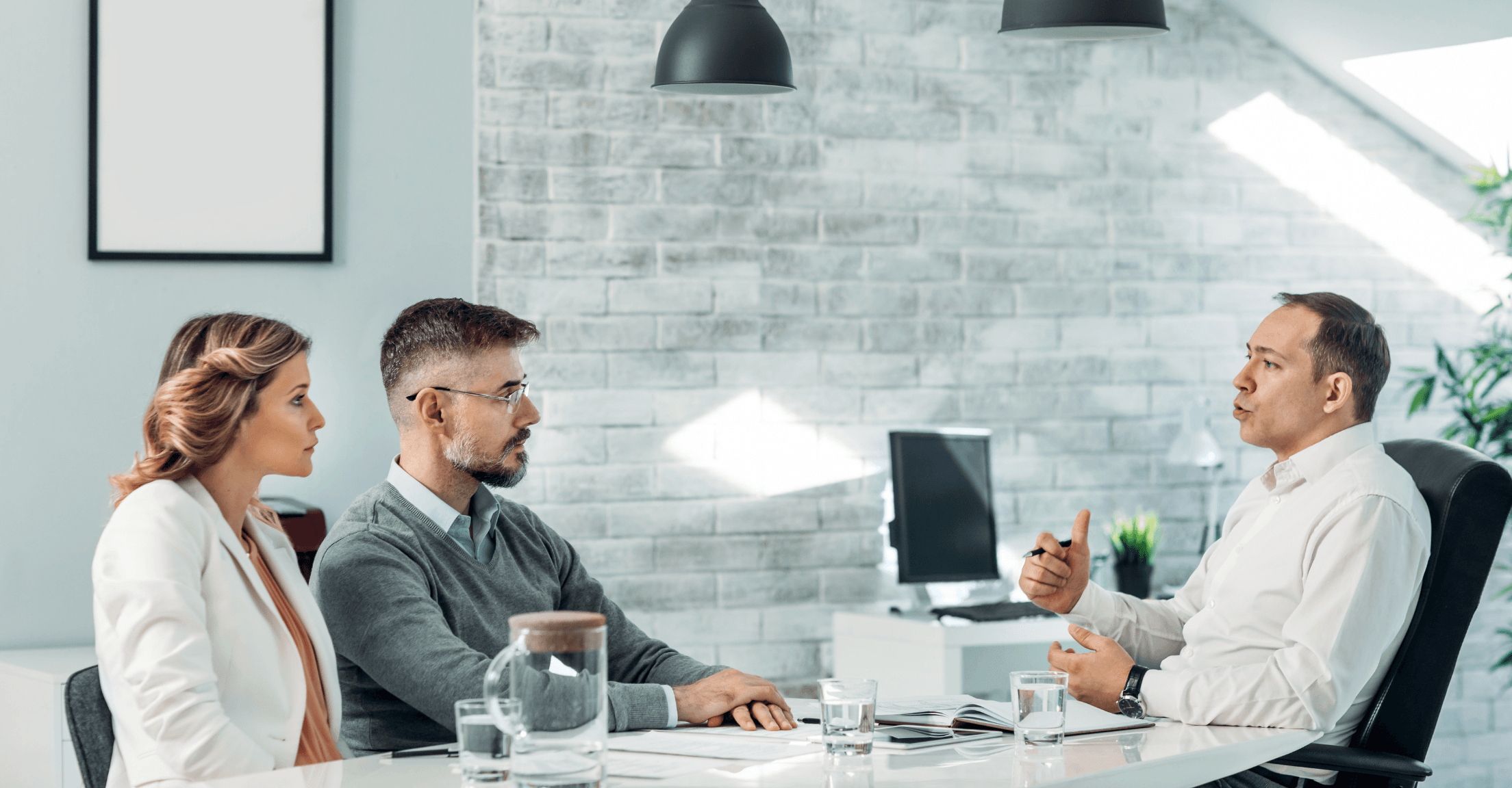 Financial advisor meeting with couple in an office