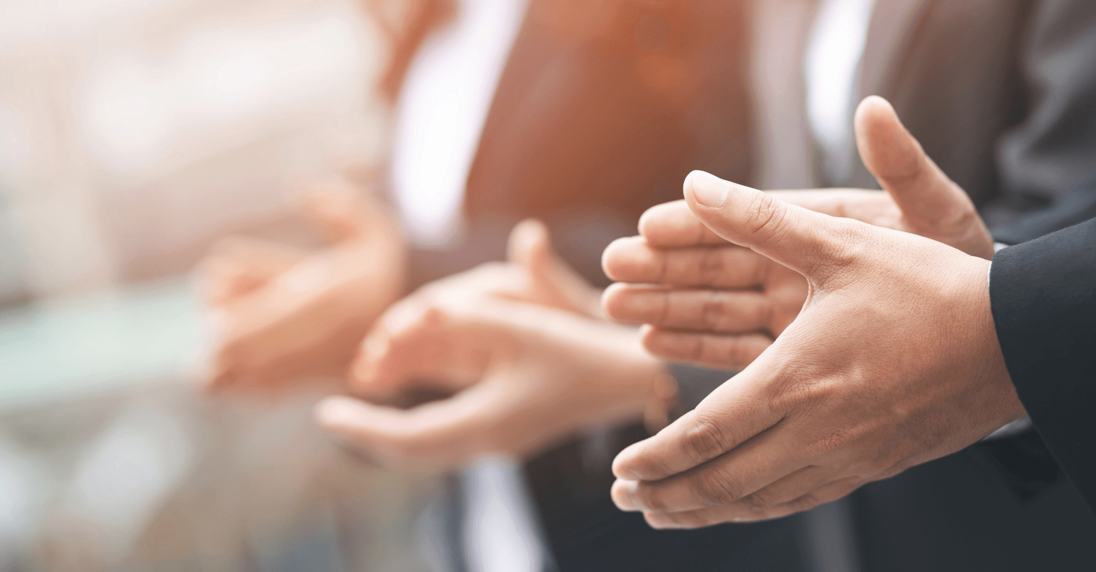 Three sets of hands applauding