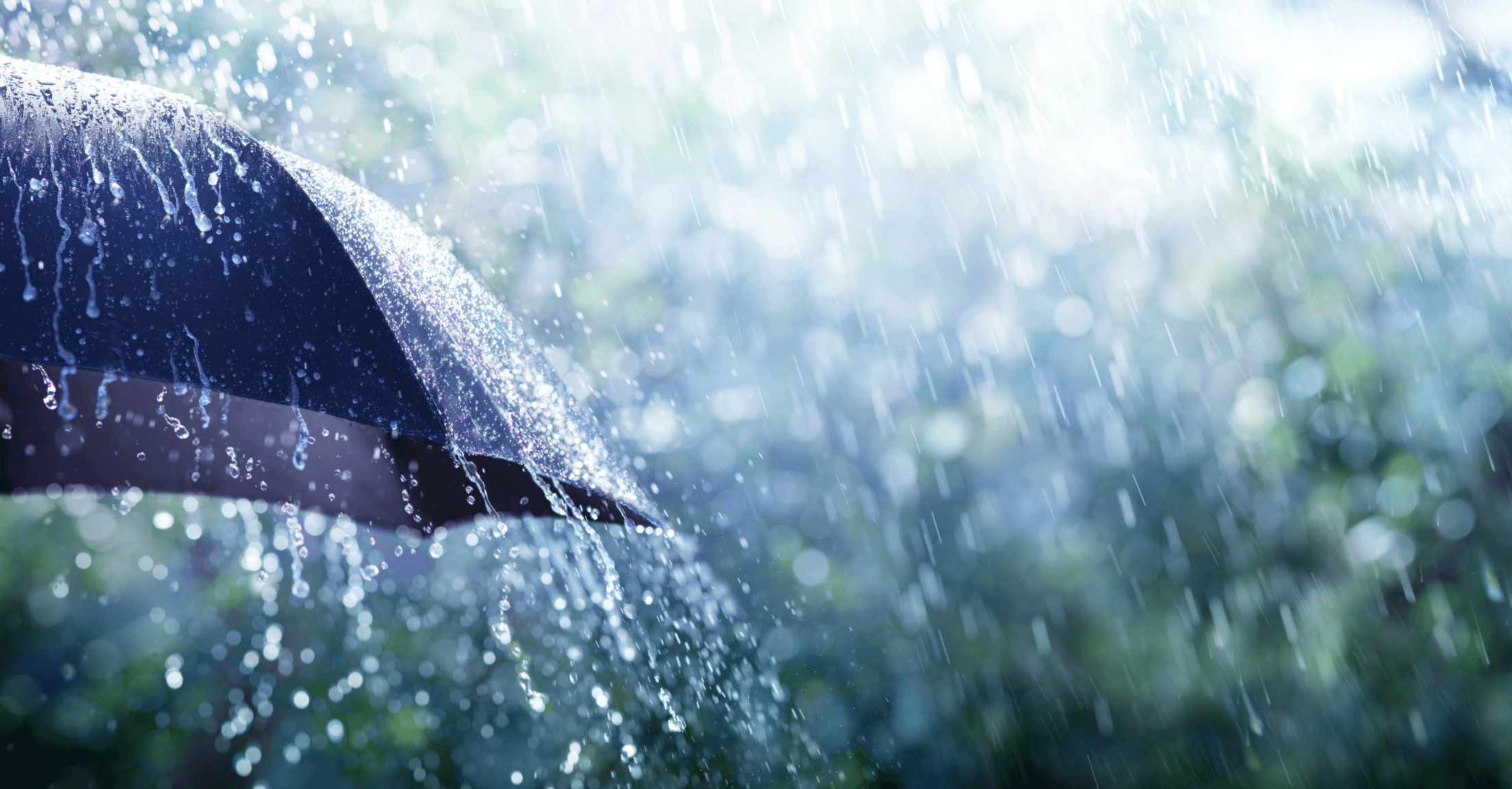 An umbrella in the rain to abstractly represent insurance