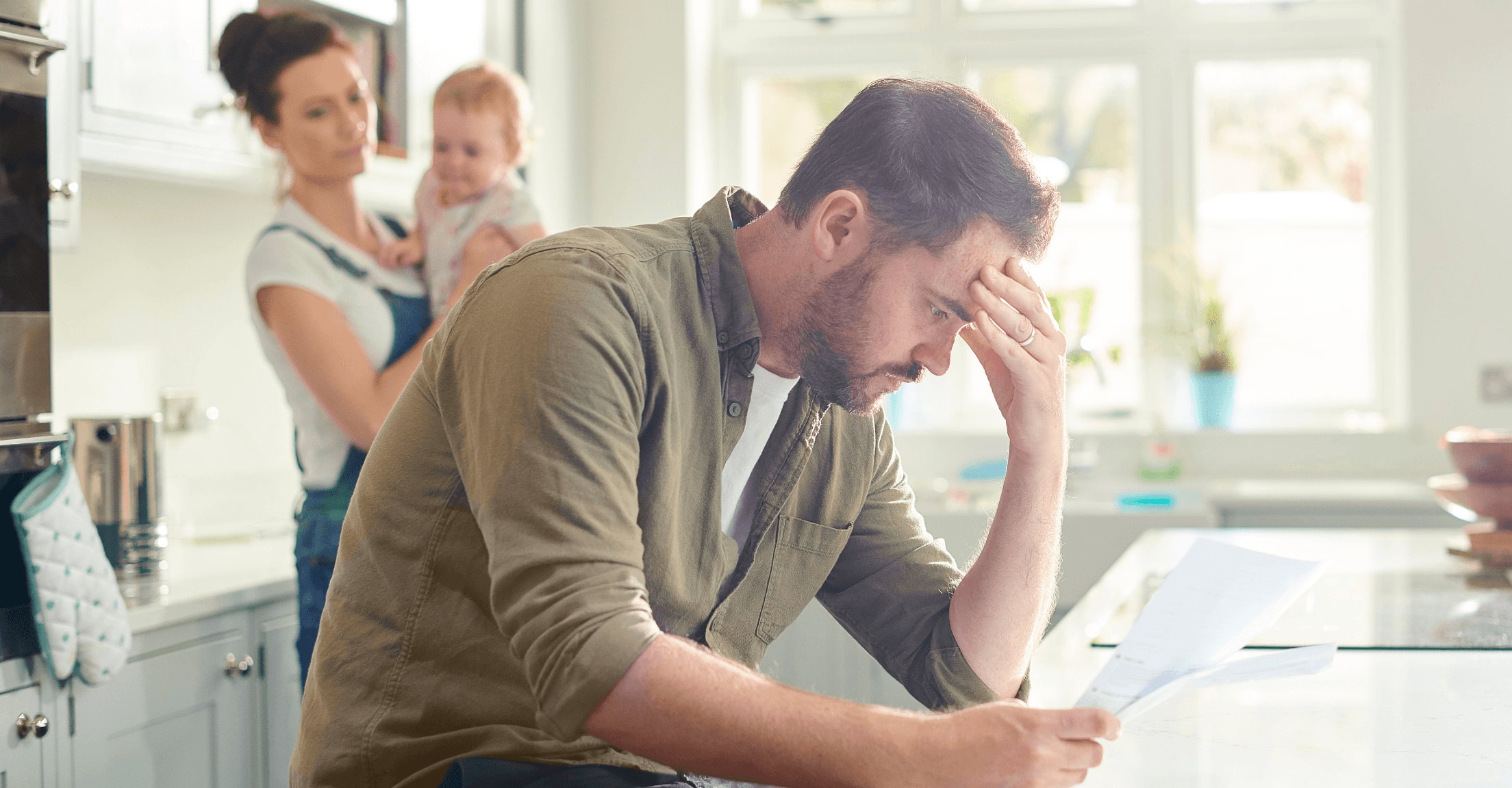 Family looking at bills distraught in kitchen