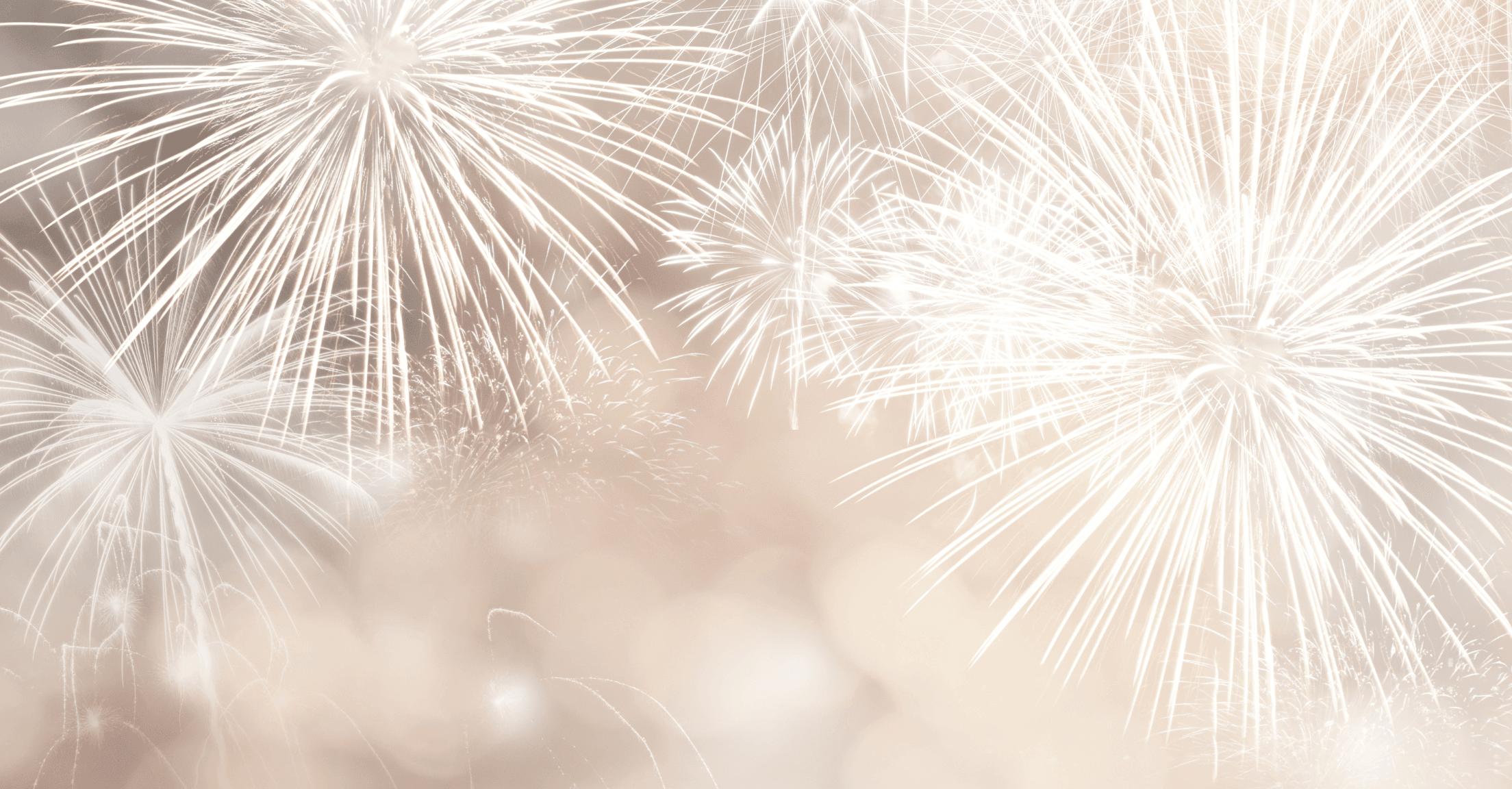 White fireworks on a beige background to represent celebrating the new year